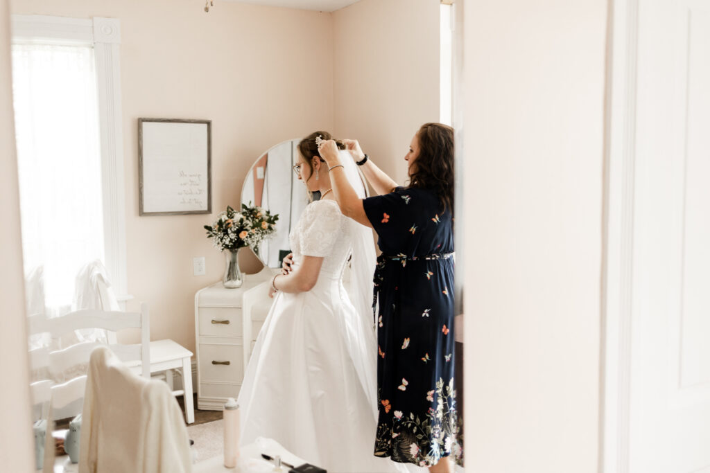 The mother of the bride placing the veil in the bride's hair at this Estate 248 wedding in Langley, British Columbia