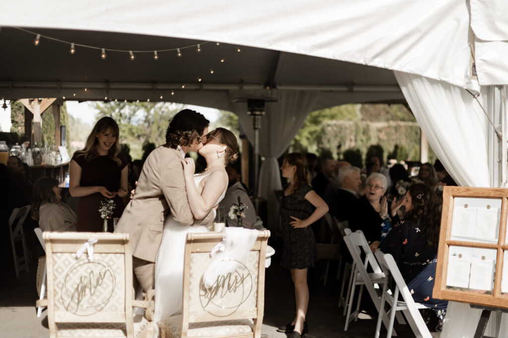 Bride and groom share a kiss at the reception at their Estate 248 wedding in Langley, British Columbia