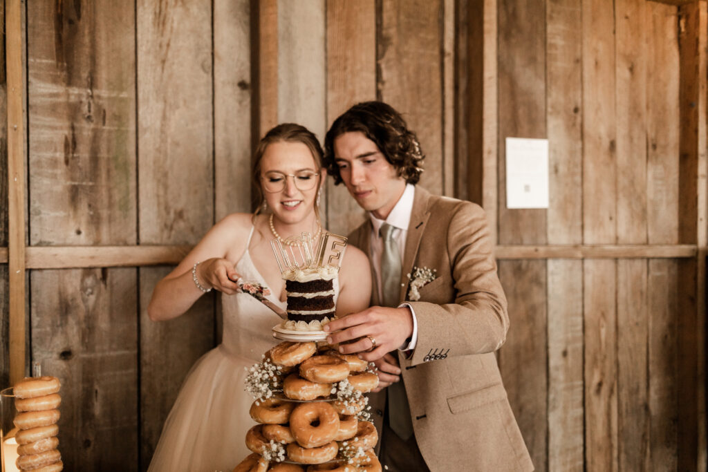 the bride and groom cut a small cake at their Estate 248 wedding in Langley, British Columbia