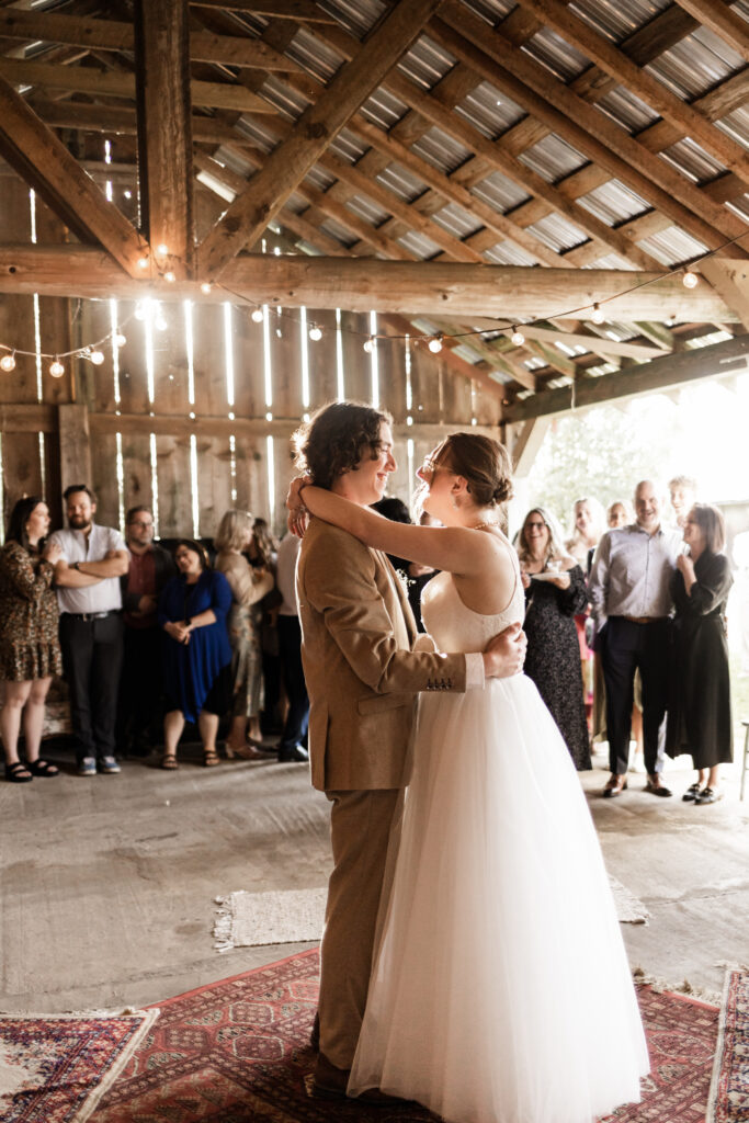 the bride and groom have a first dance surrounded by guests at their Estate 248 wedding in Langley, British Columbia