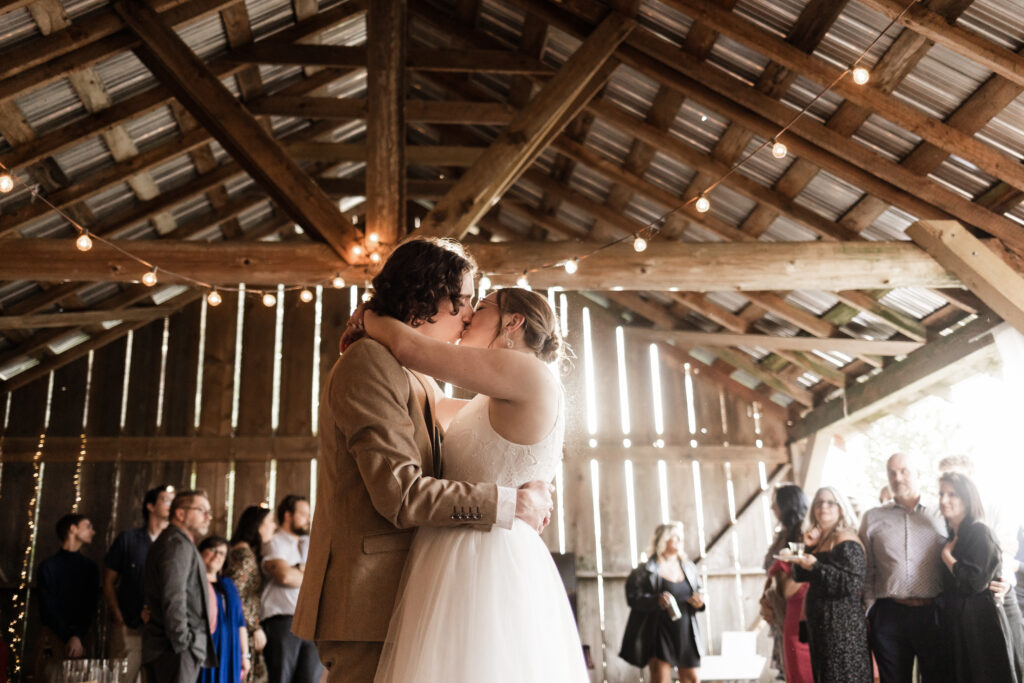 the bride and groom share a kiss during their romantic first dance at this Estate 248 wedding in Langley, British Columbia