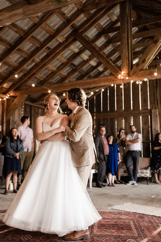 the groom spins the bride during their first dance at this Estate 248 wedding in Langley, British Columbia