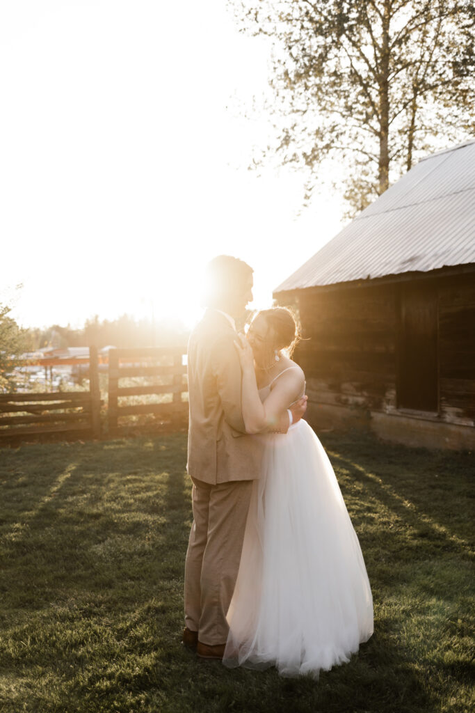 bride and groom hold each other and laugh as the golden sun shines in from behind at this Estate 248 wedding in Langley, British Columbia