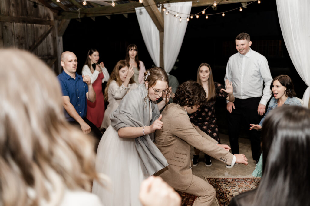 the bride and groom get low on the dance floor at their Estate 248 wedding in Langley, British Columbia