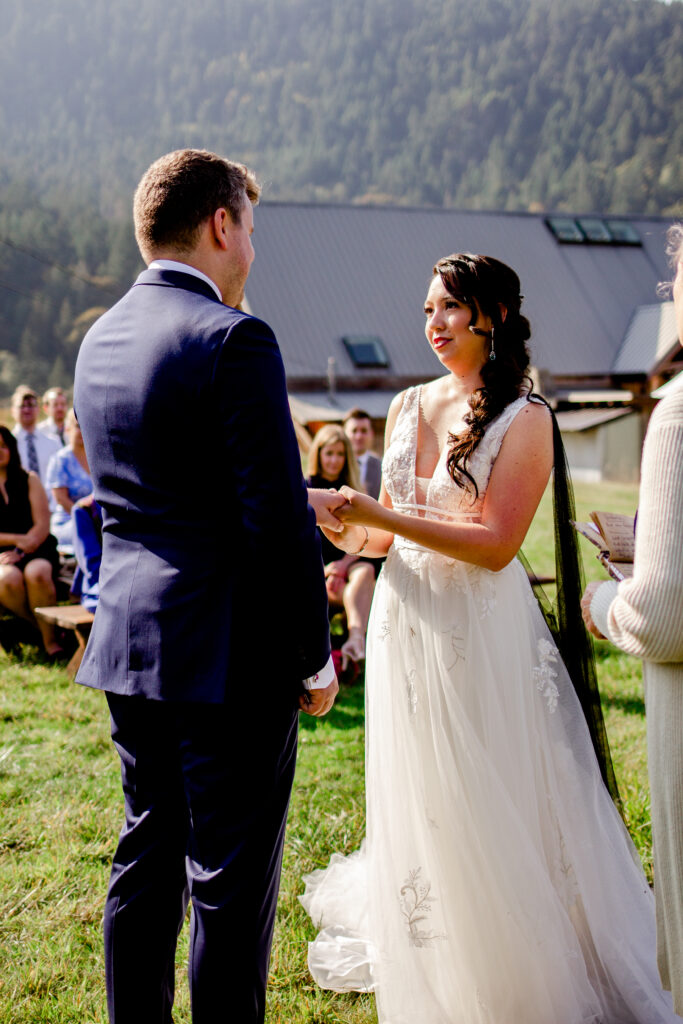 Bride and groom exchange rings at this Bird's Eye Cove wedding