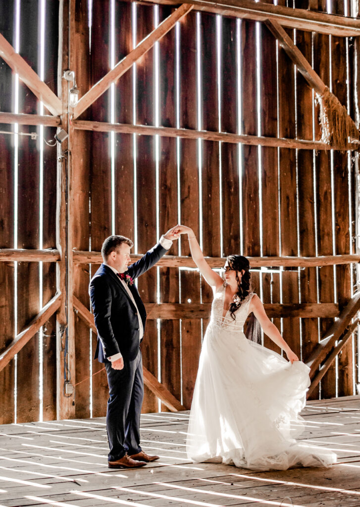 Bride and groom dance in the barn at this Bird's Eye Cove wedding