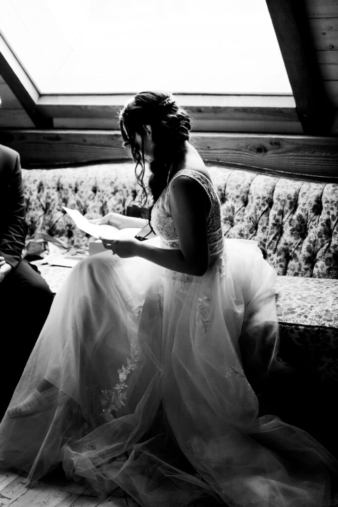 Bride reads letter from the groom at this Bird's Eye Cove wedding