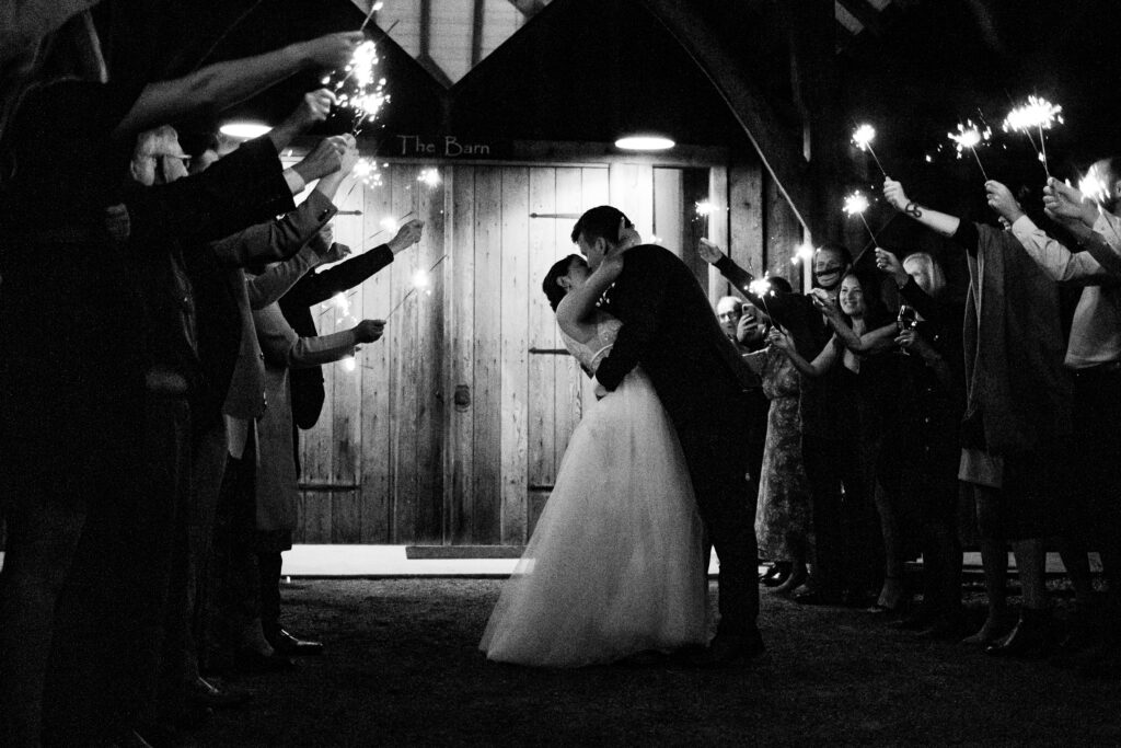 Bride and groom are sent off with a sparkler exit at this Bird's Eye Cove wedding