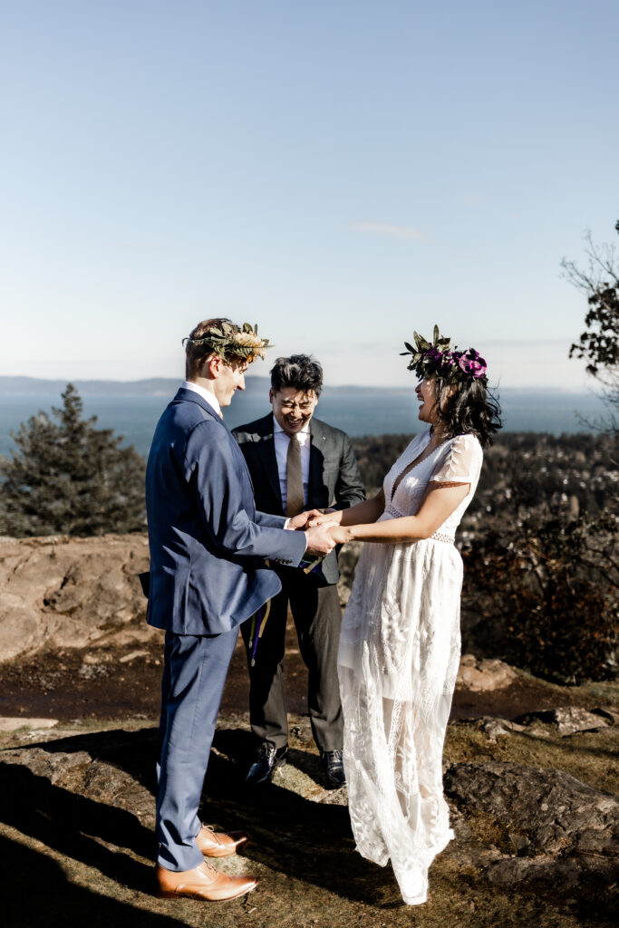 A couple shares a laugh standing at the altar at a Mount Douglas Elopement.