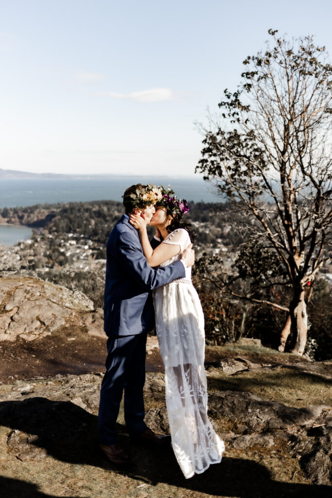 The newly weds share their first at the top of the mountain at a Mount Douglas Elopement.