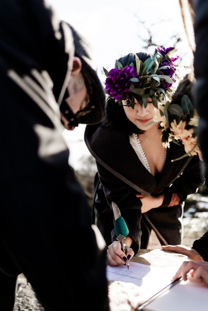 The bride signs the marriage papers at a Mount Douglas Elopement.