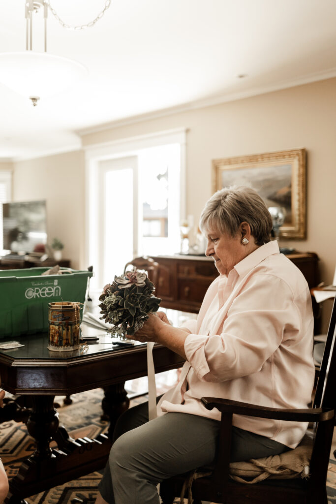 Bride's grandmother putting together bouquets at this Victoria wedding