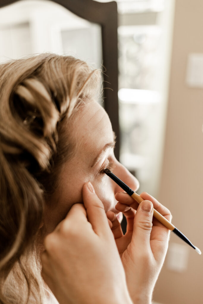 Bride getting makeup done at this Victoria wedding