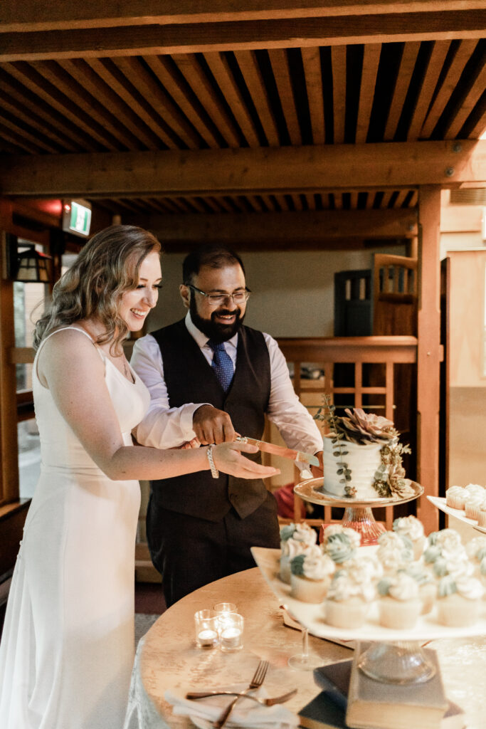 bride and groom cut the cake at this Victoria wedding