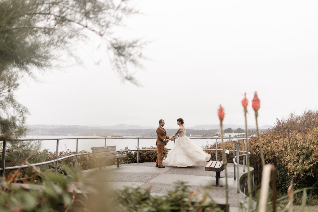 bride and groom dance together at saxe point park at this punk wedding in Victoria, BC