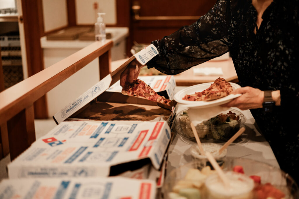 guests eat pizza at this punk wedding in Victoria, BC