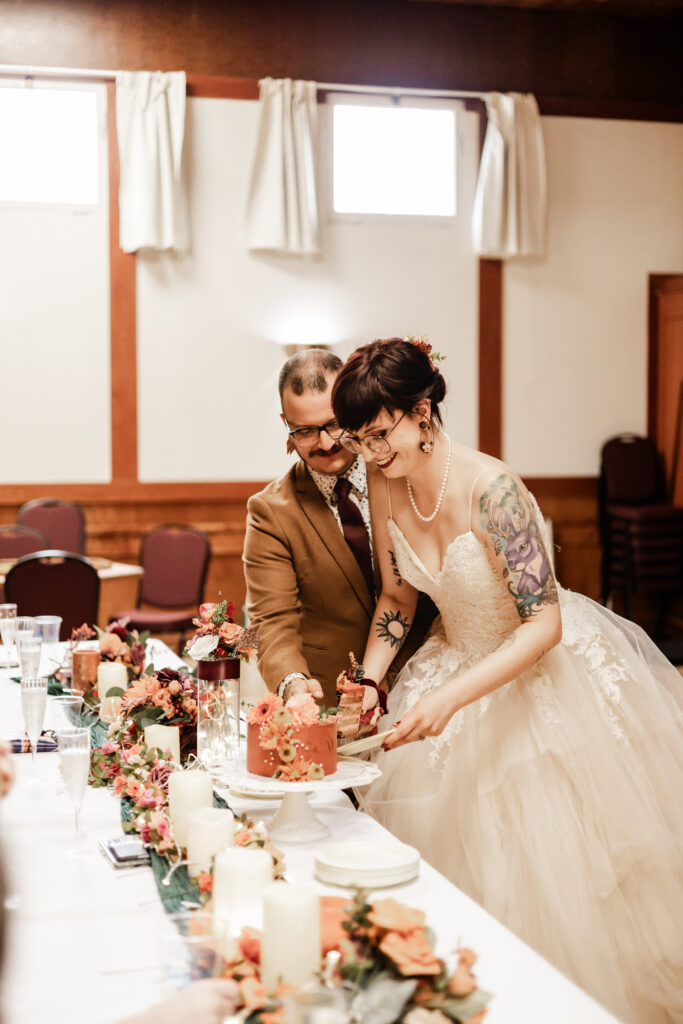 bride and groom cut their cake at this punk wedding in Victoria, BC