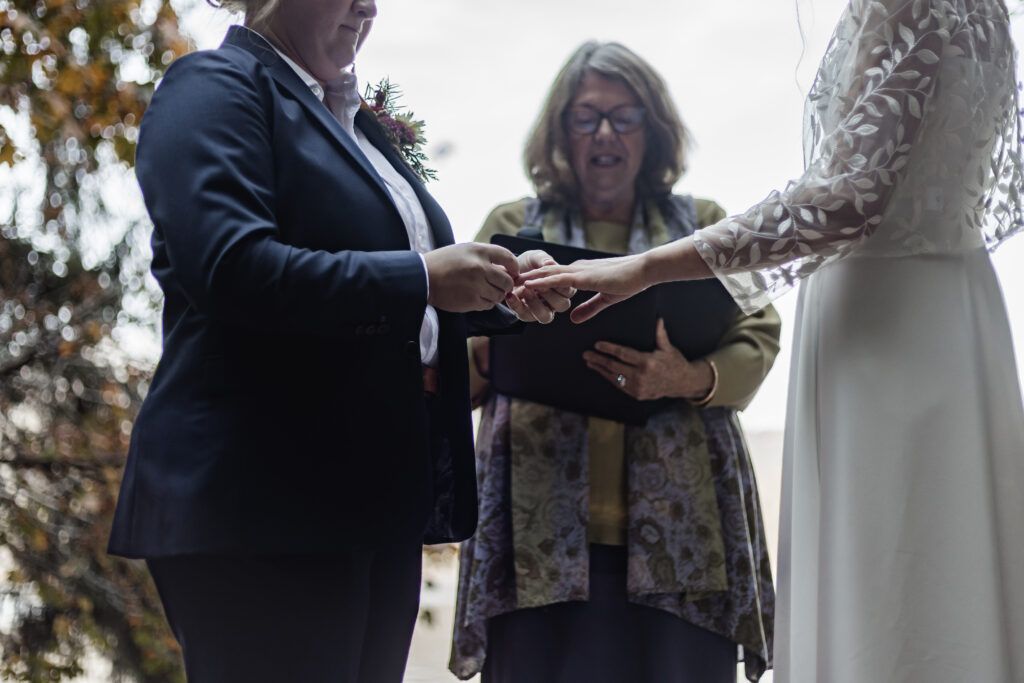 An upclose of the couple exchanging rings at this Camp Elphinstone wedding.