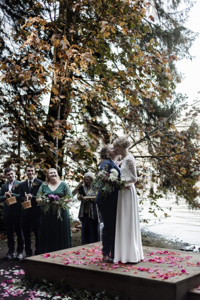 The couple shares their first kiss as newlyweds at this Camp Elphinstone wedding.