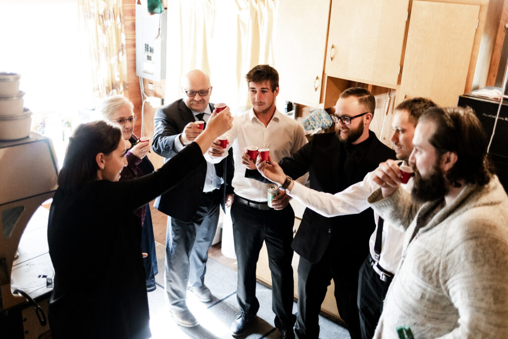 The groomsmen share a shot at this cabin elopement