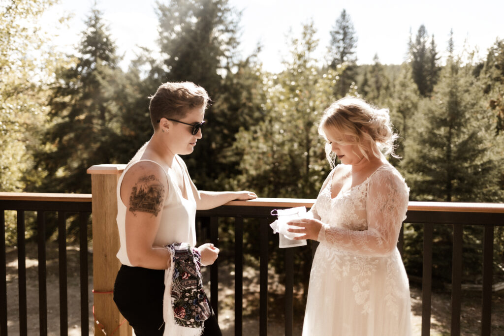 Bride opens gift from sister at this cabin elopement