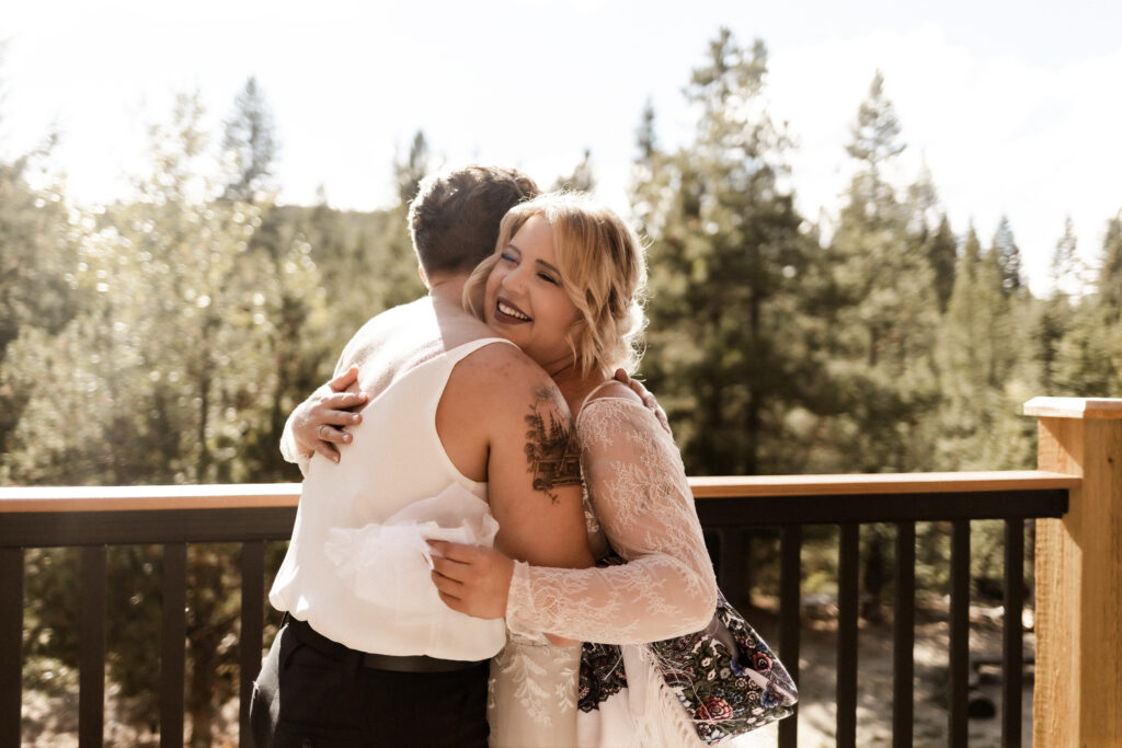 Bride opens gift from sister at this cabin elopement