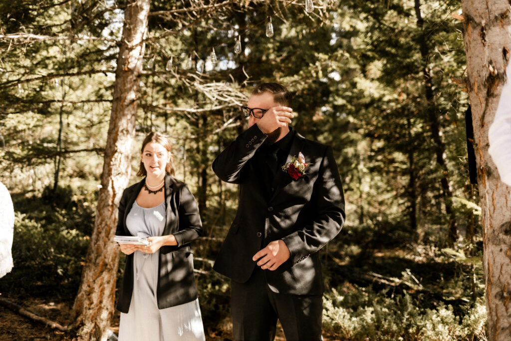 Groom cries as his bride walks down the aisle at this cabin elopement