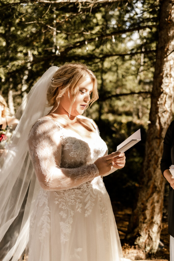 bride reads vows at this cabin elopement