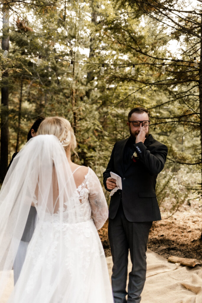 Groom cries as he reads vows at this cabin elopement