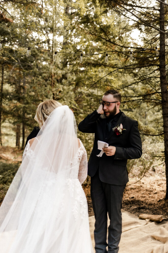 Groom cries as he reads vows at this cabin elopement