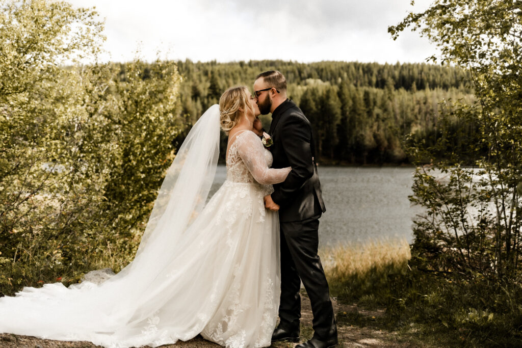 The couple share another first kiss as a legally wed couple at this cabin elopement