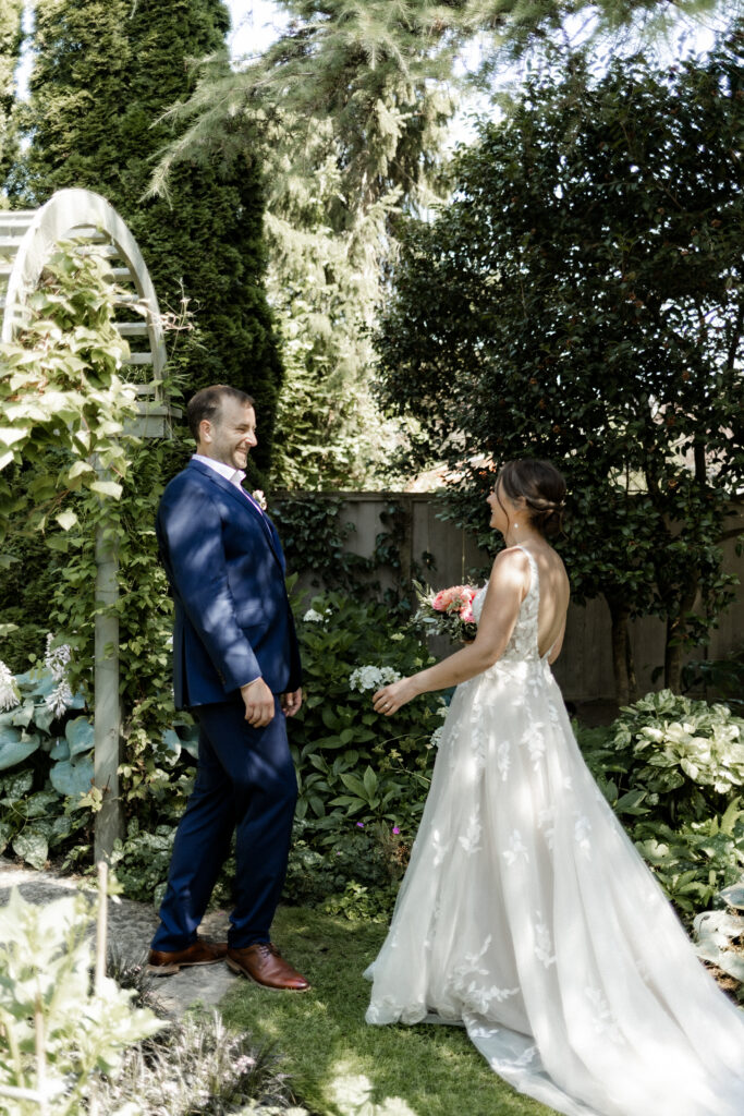 The couple share a first look at their garden party wedding.