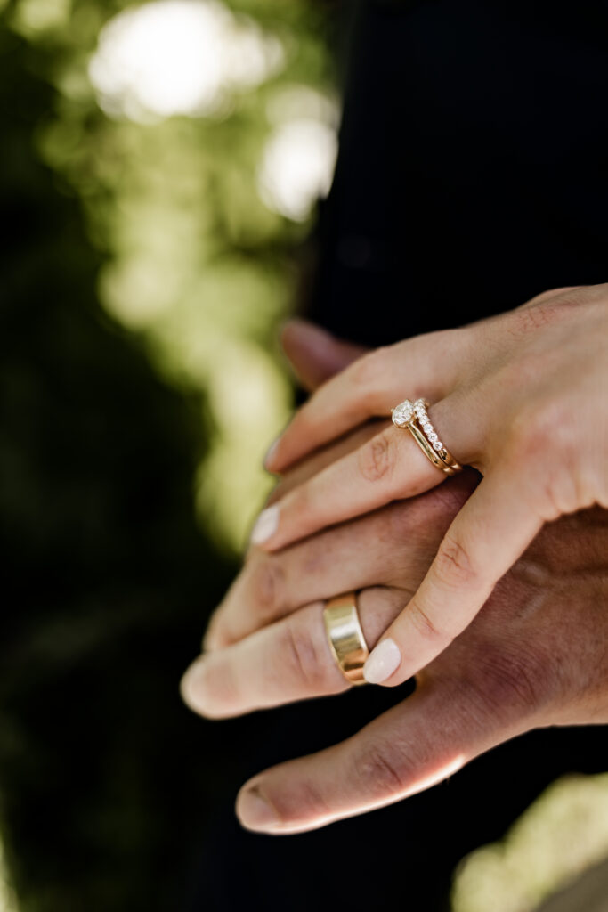 An upclose of the bride and grooms rings at their garden party wedding