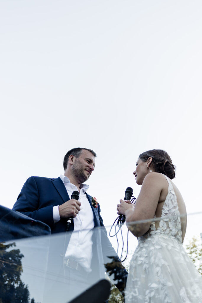 The bride and groom give a speech of thanks to their guests at their garden party wedding