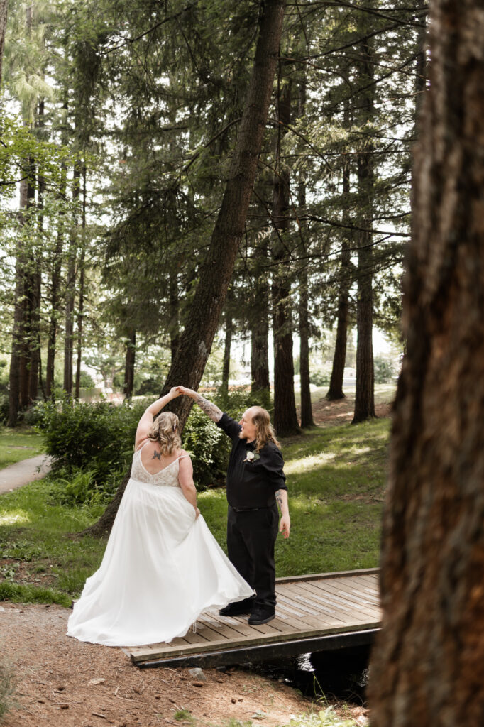 Groom twirls his bride at their backyard wedding in Mission