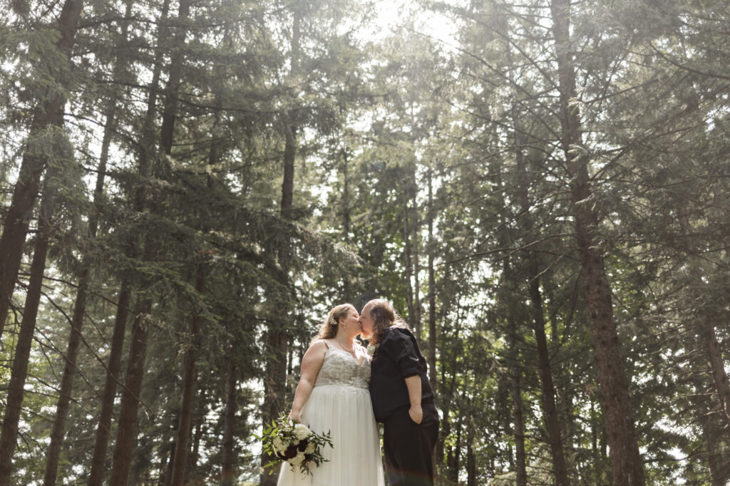 Bride and groom go in for a kiss at their backyard wedding in Mission