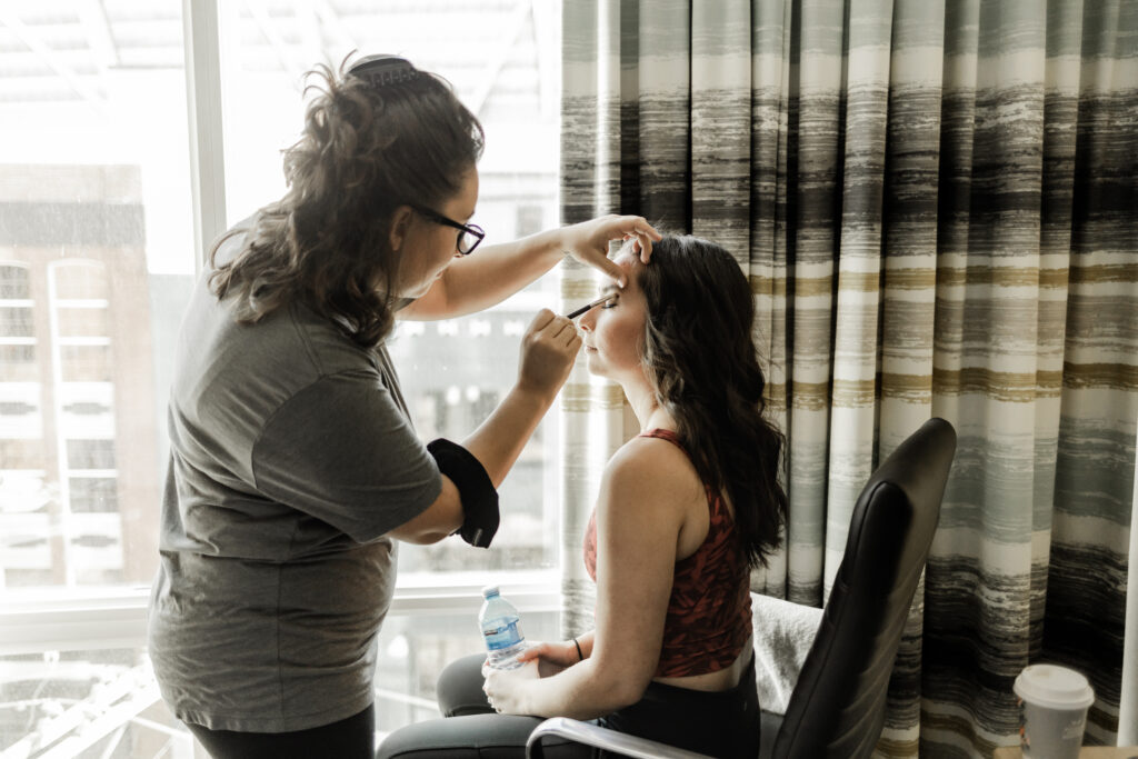 Bride gets her makeup done at this downtown Vancouver wedding