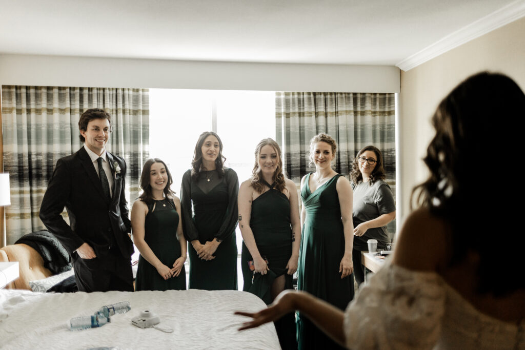 Bride has a first look in her dress with her bridal party at this downtown Vancouver wedding