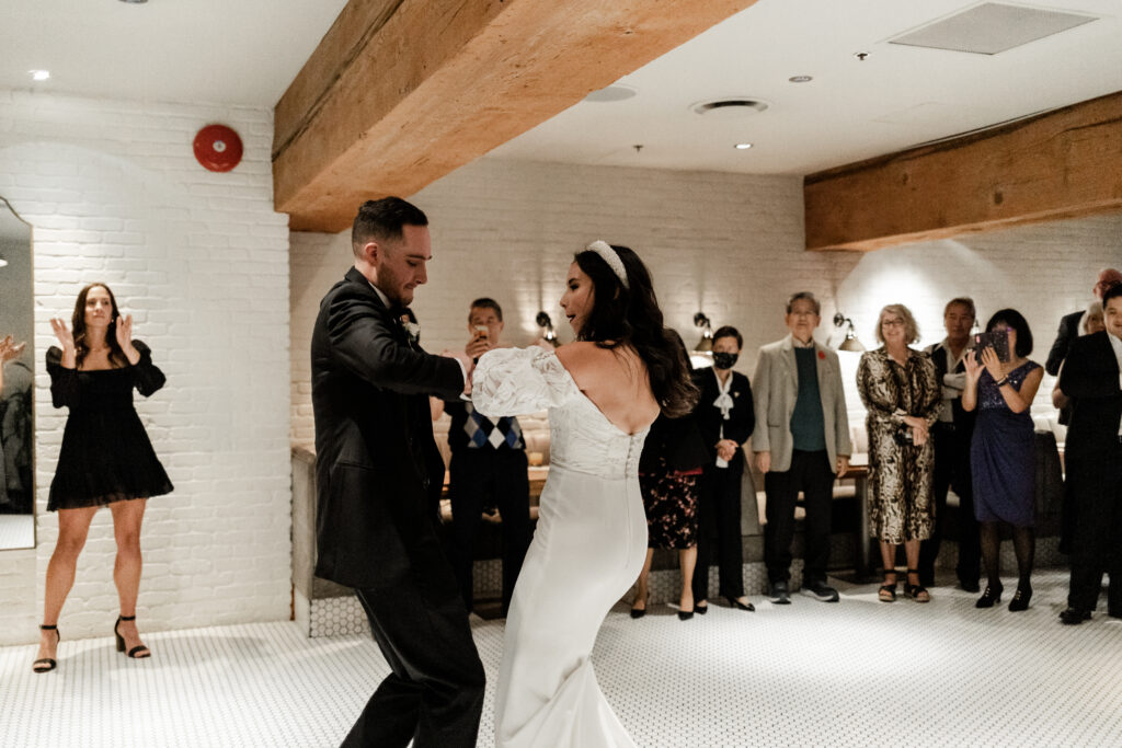 Bride and groom enter their reception by dancing into the Loft at Earls at this downtown Vancouver wedding