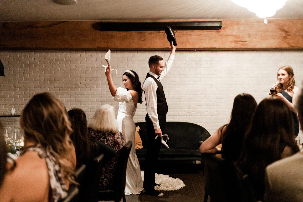 Bride and groom play the shoe game at Loft at Earls at this downtown Vancouver wedding