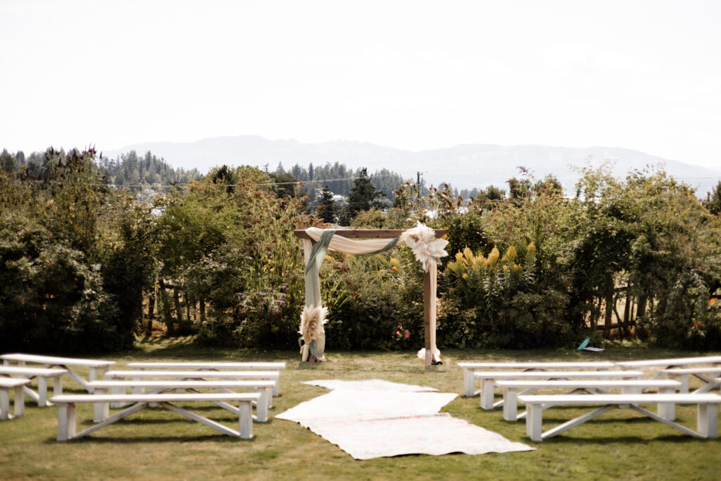 Ceremony space, including the altar, benches, and rug aisle at this Kildara Farms wedding