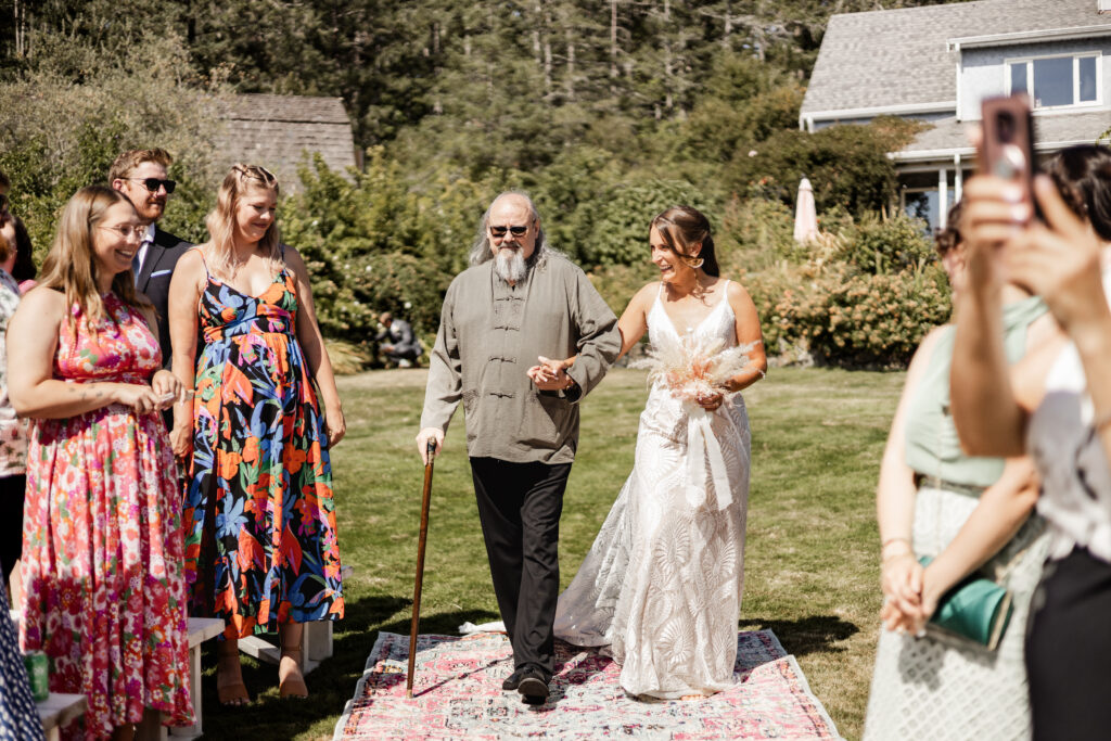 The bride is walked down the aisle by her dad at this Kildara Farms wedding