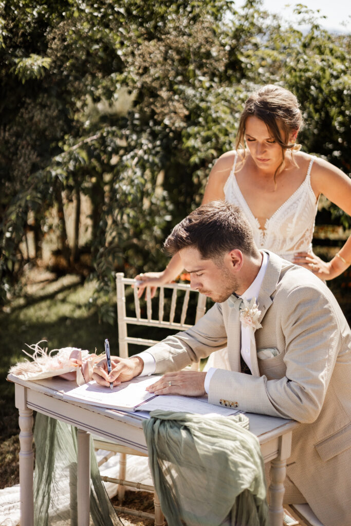 The groom signs the marriage papers at this Kildara Farms wedding