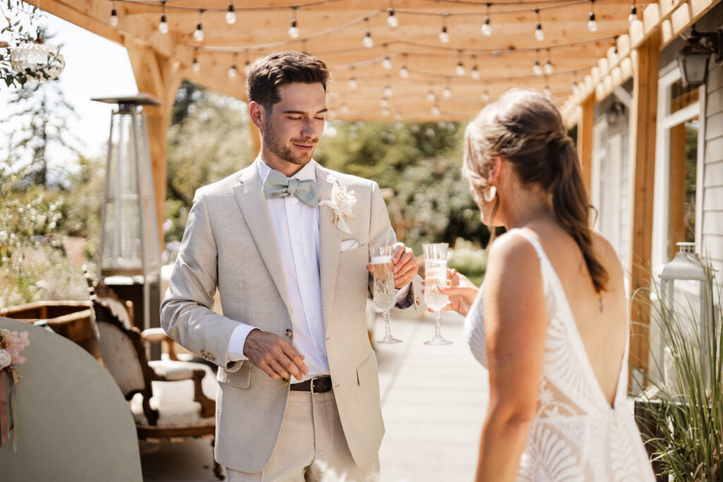 The newly couple cheers with their glasses of champagne at this Kildara Farms wedding