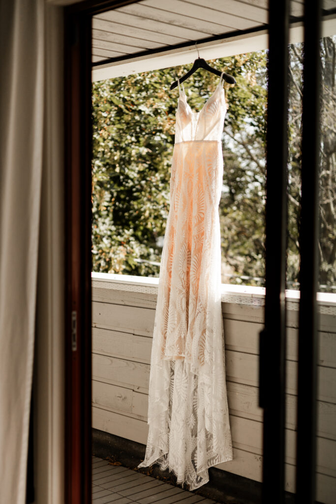 Brides boho style dress hanging on the patio at this Kildara Farms Wedding