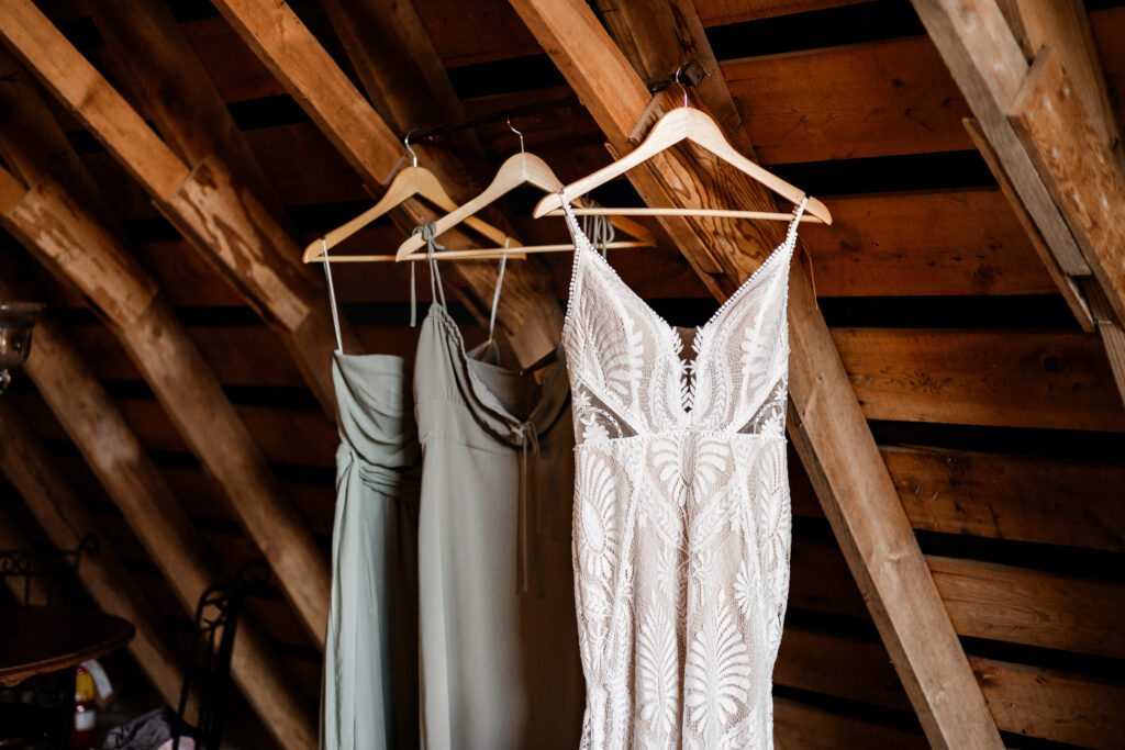 Wedding dress and bridesmaids dresses hanging up in the loft at this Kildara Farms Wedding