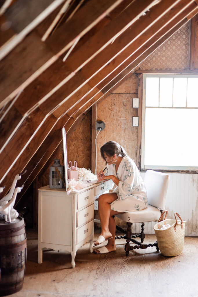 The bride writes her vows in her vow book at this Kildara Farms wedding