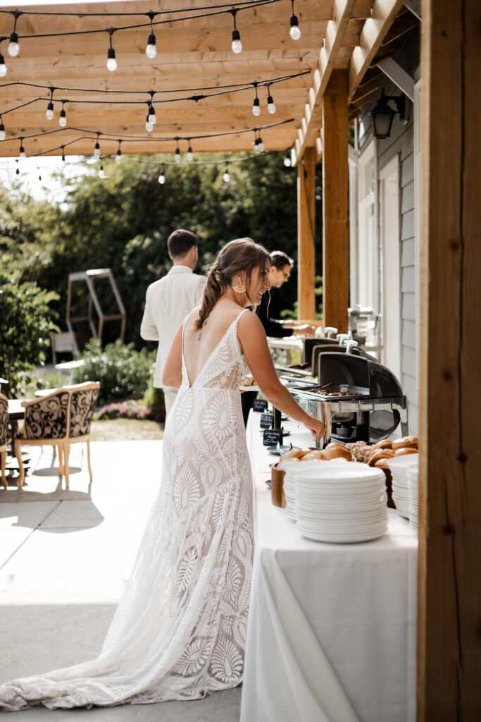 The bride and groom fill up their dinner plates at this Kildara Farms wedding