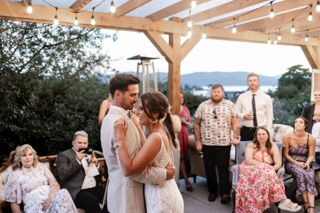 The bride and groom have a romantic first dance under the fairy lights at this Kildara Farms wedding