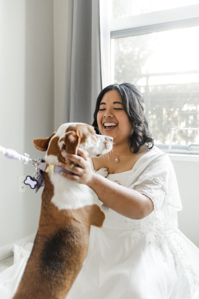 Bride has a first look with her dog before her wedding at Seasons Restaurant